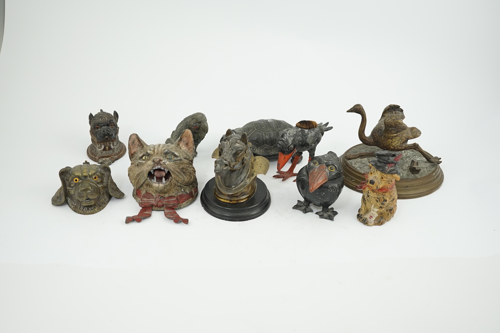 A collection of nine 19th and 20th century novelty animal bronze and metal ink wells, including a Martin Brothers-style ‘Wally’ inkwell. Condition - minor chips due to use and age